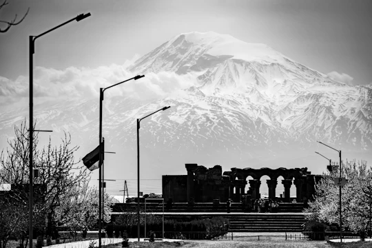 Ancient ruins and a mountain range are visible.