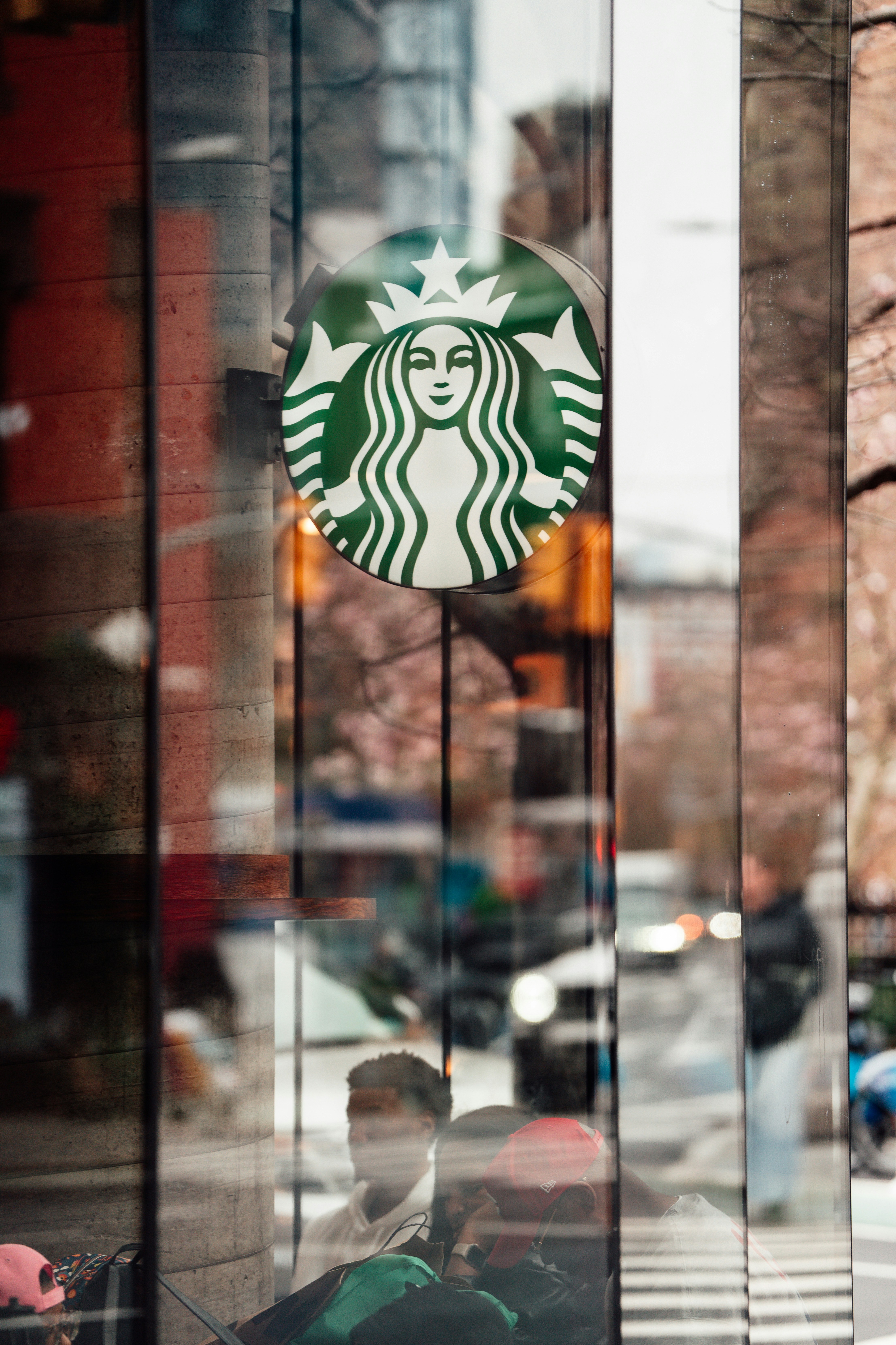 Starbucks logo reflected in a glass window.