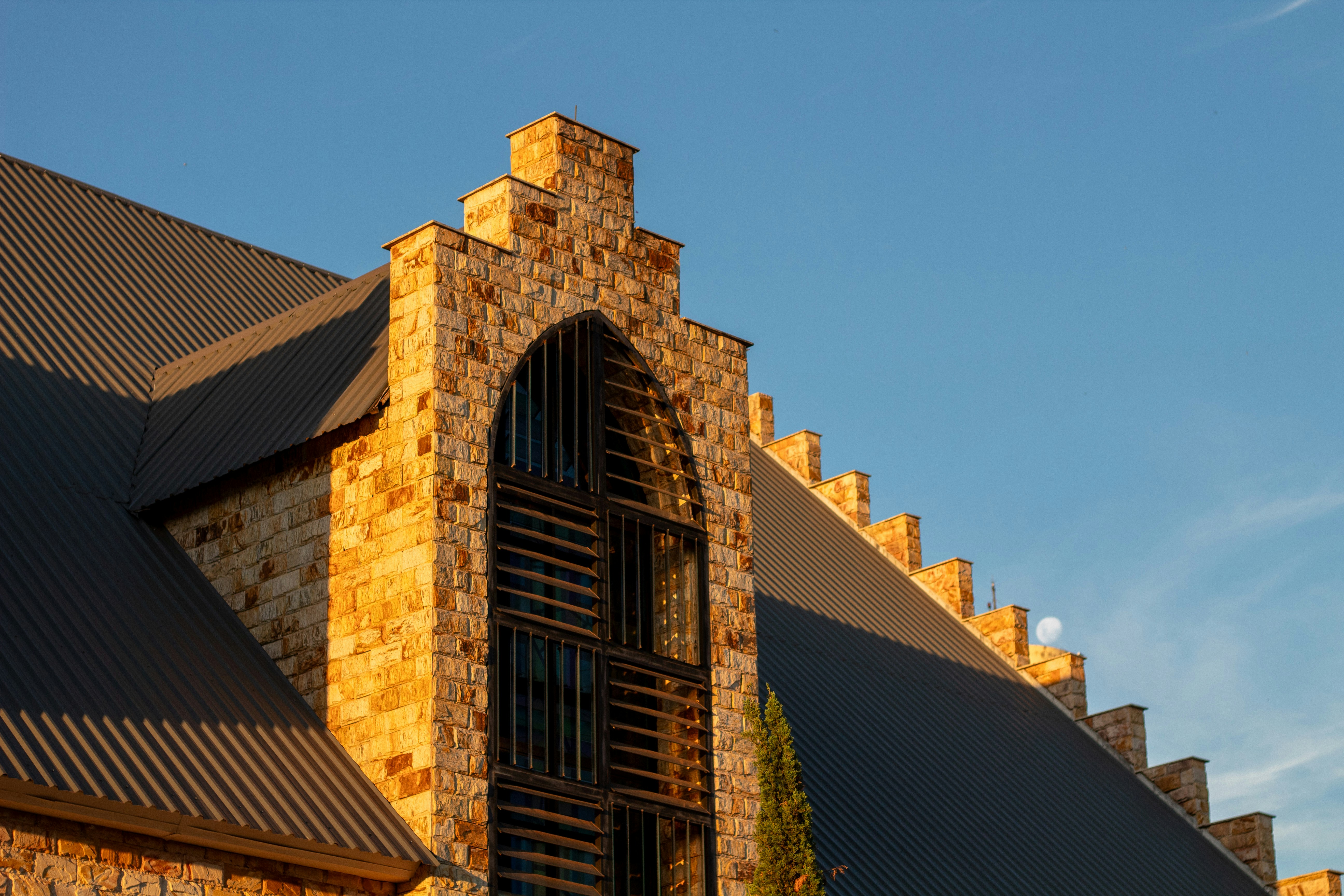 A building's facade is seen against a blue sky.