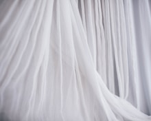 White, flowing fabric creates a delicate, airy display.