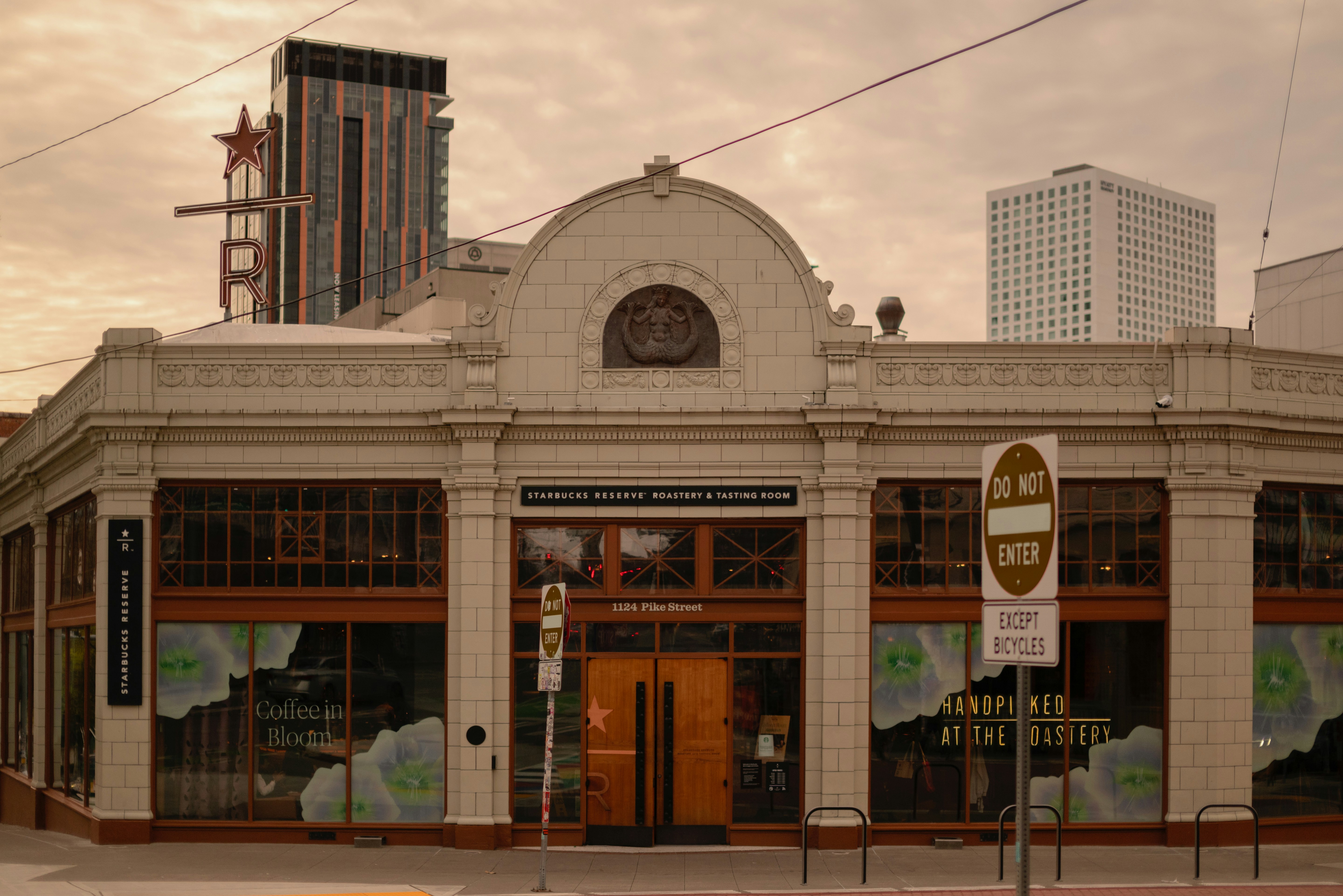 An old building with tall skyscrapers in the background.