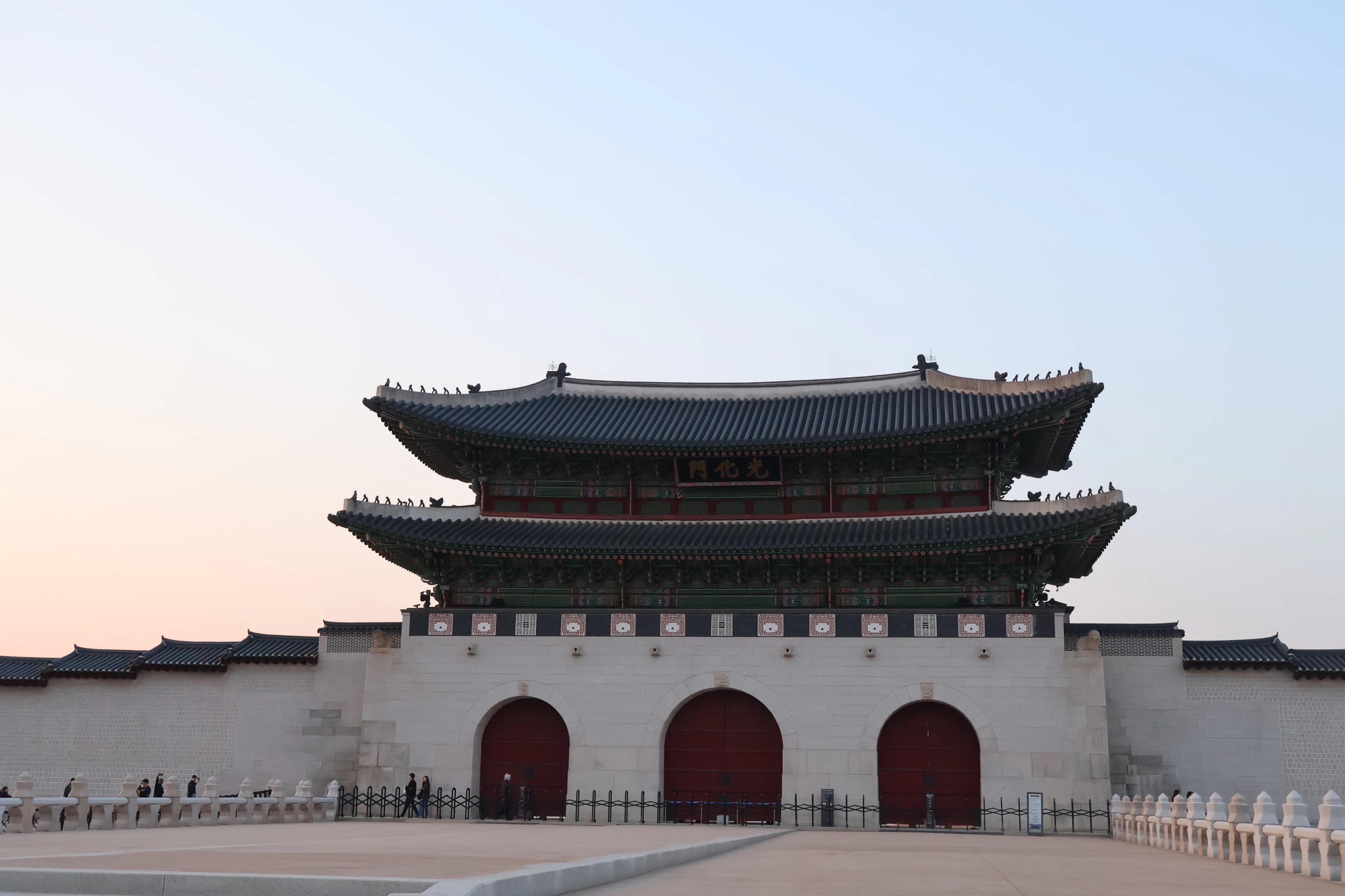 Gwanghwamun gate at Gyeongbokgung in Seoul, its painted timber bracketing above the stone arches