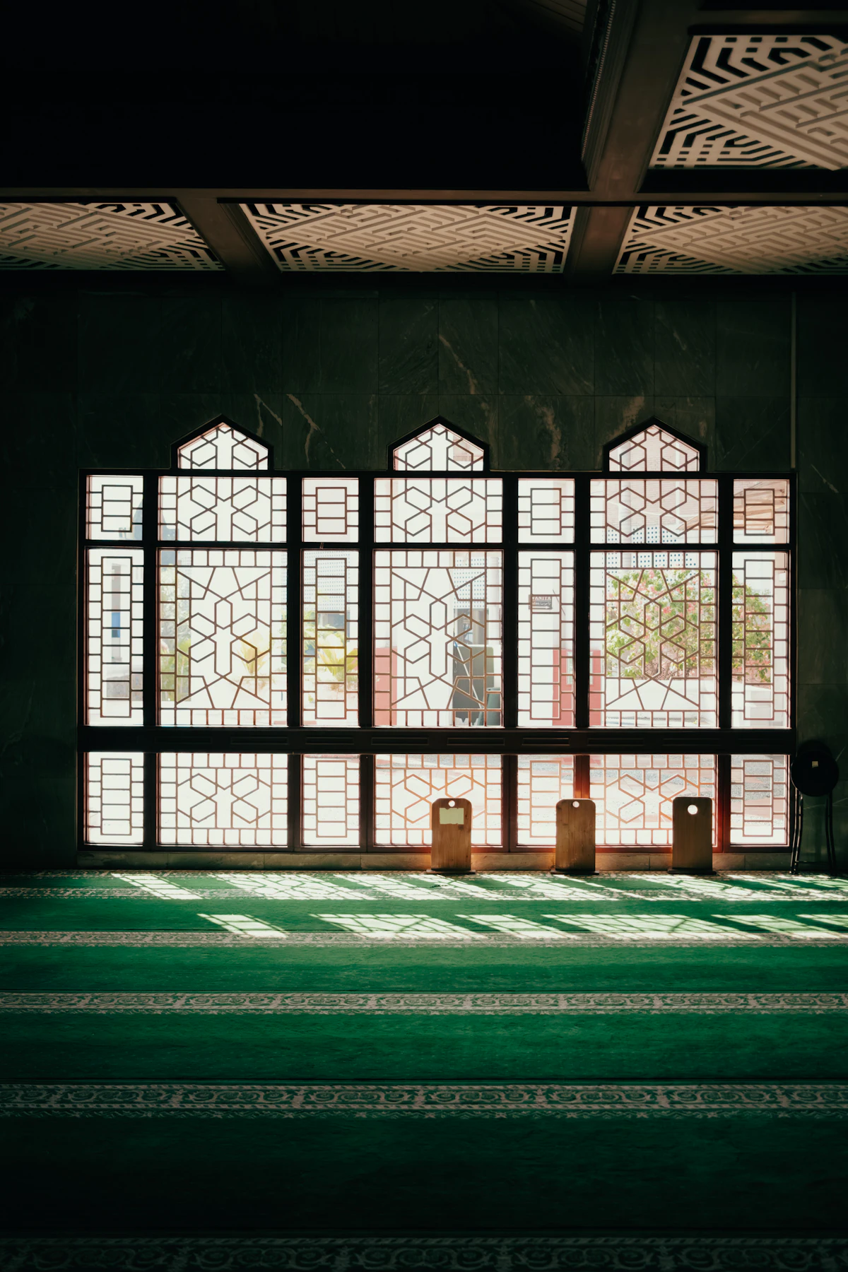 Light streaming through geometric windows in a mosque — Islamic counselling in Mississauga