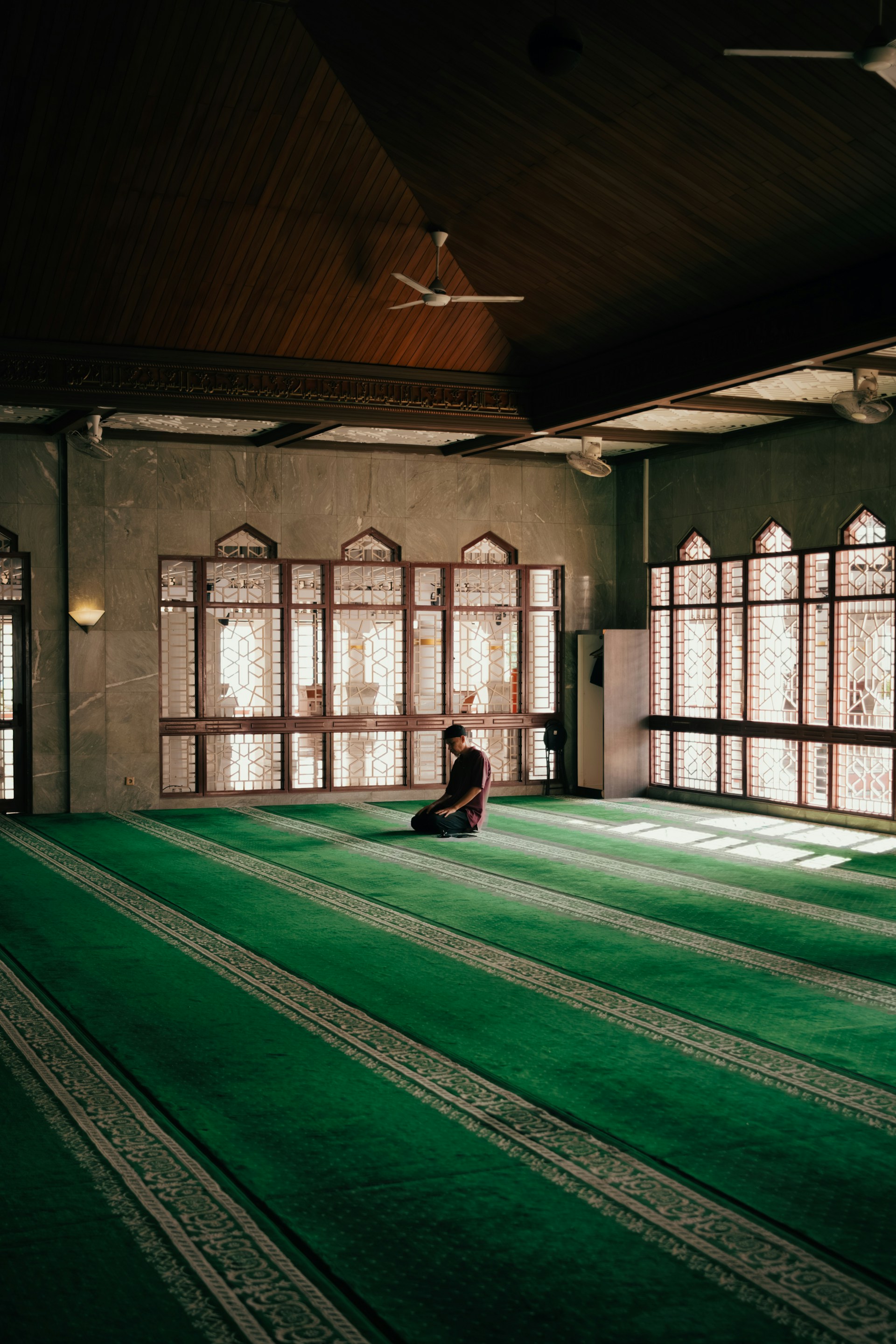 A man prays silently in a mosque.