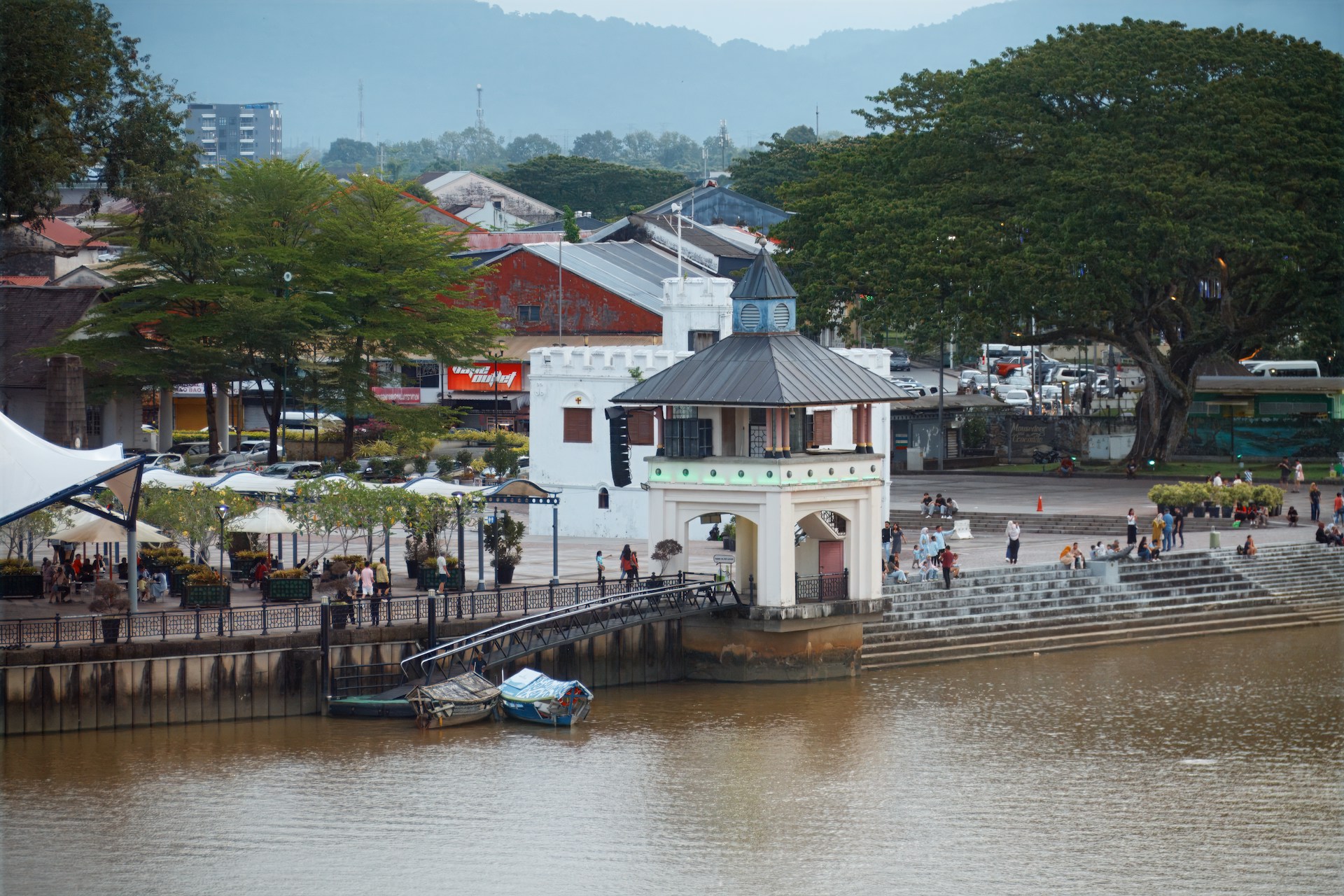 Riverside architecture and green trees.
