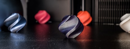 Several colorful, swirled objects are resting on a surface.