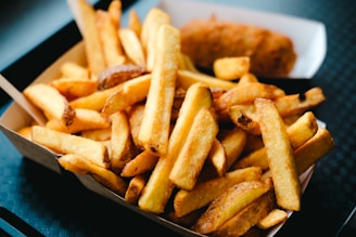 Crispy fries and fried food on a tray.