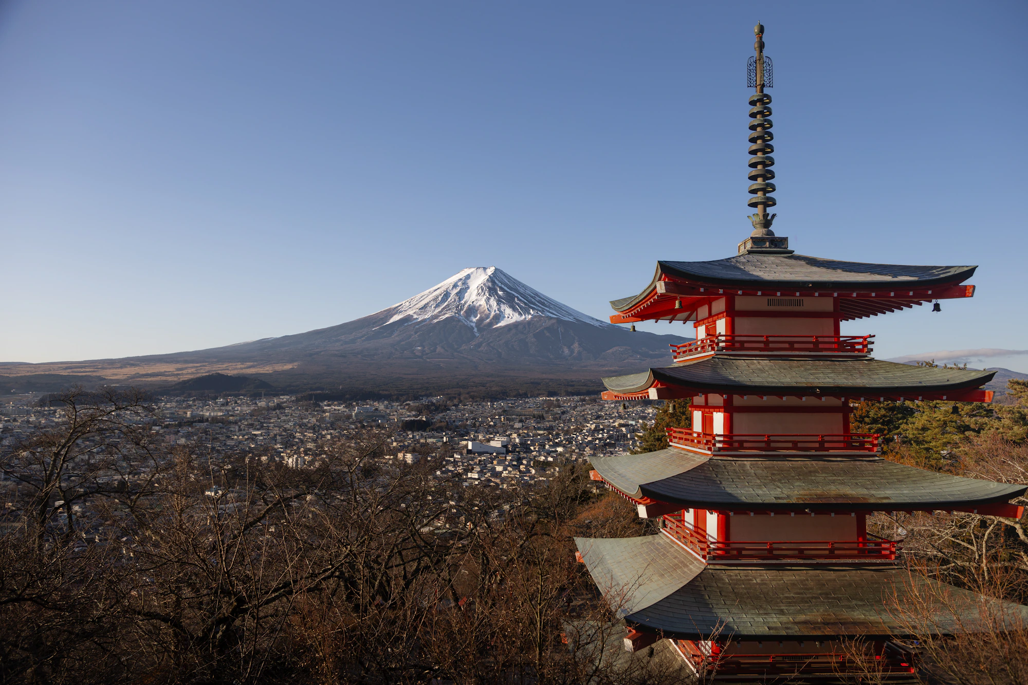 Mount Fuji behind a pagoda under a clear sky