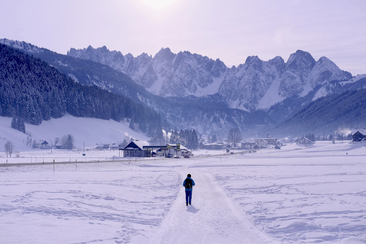 Wide groomed pistes above an Austrian ski resort under blue sky