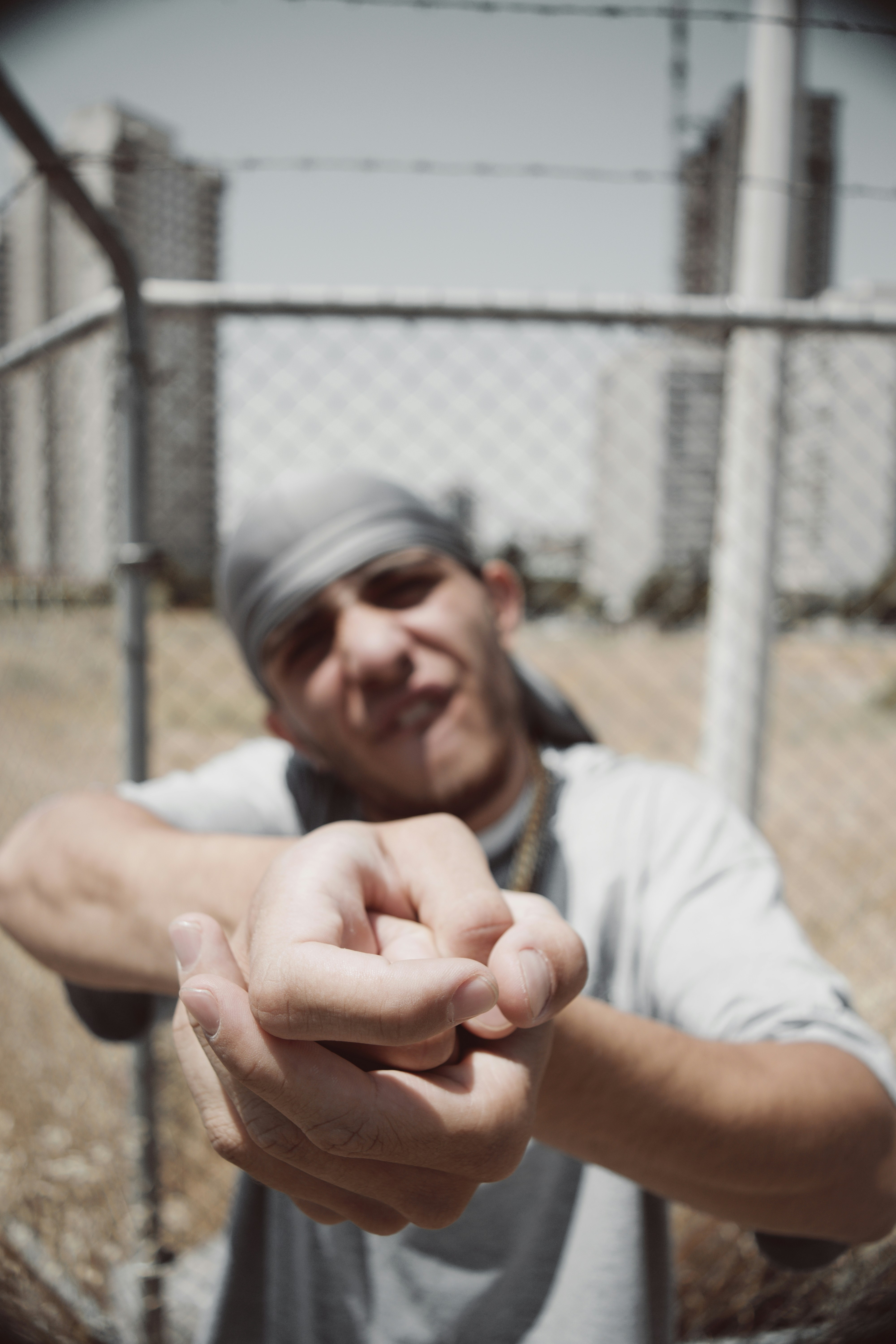 A man gestures aggressively with clasped hands.