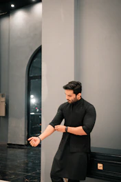 A man rolls up his sleeves.