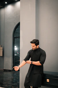 A man rolls up his sleeves.