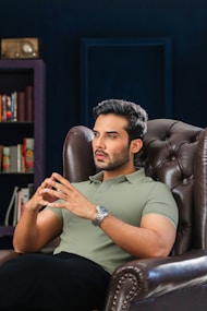 A man is deep in thought while sitting.