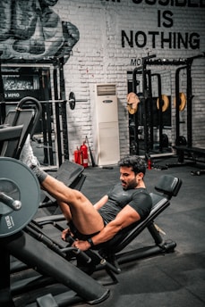 Man is working out on a leg press machine.
