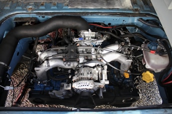 A car engine is visible inside its hood.
