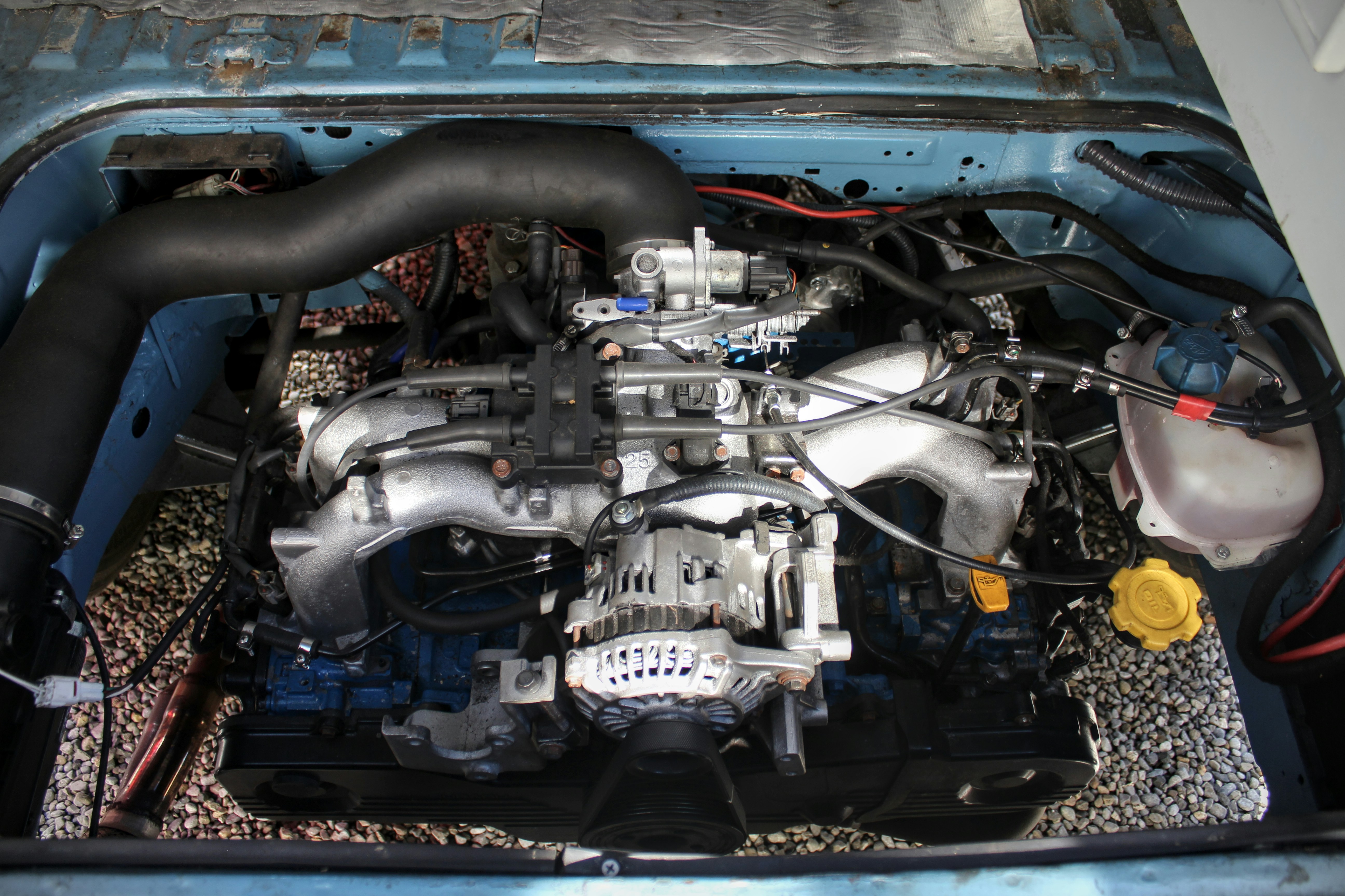 A car engine is visible inside its hood.