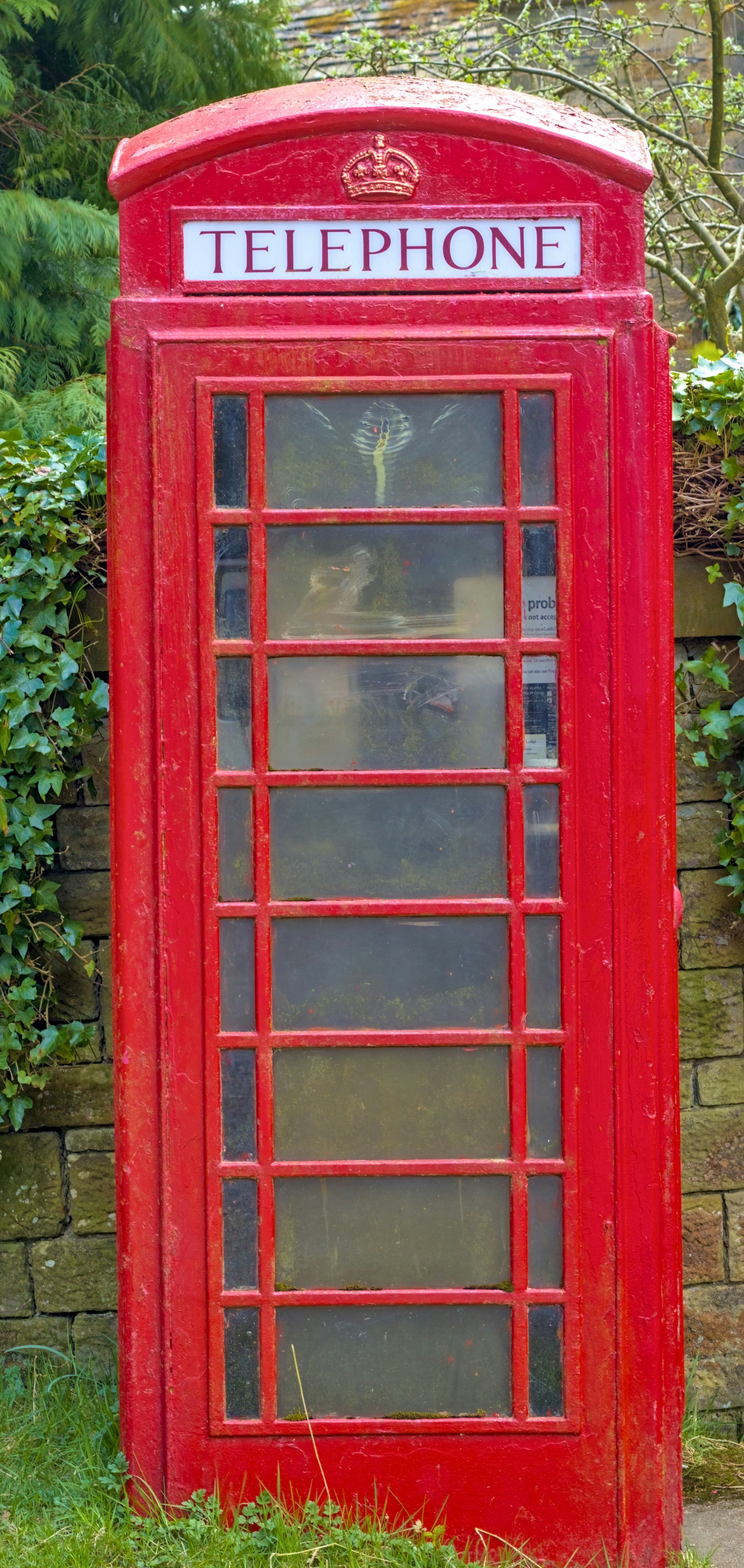 A classic red telephone box stands outside.