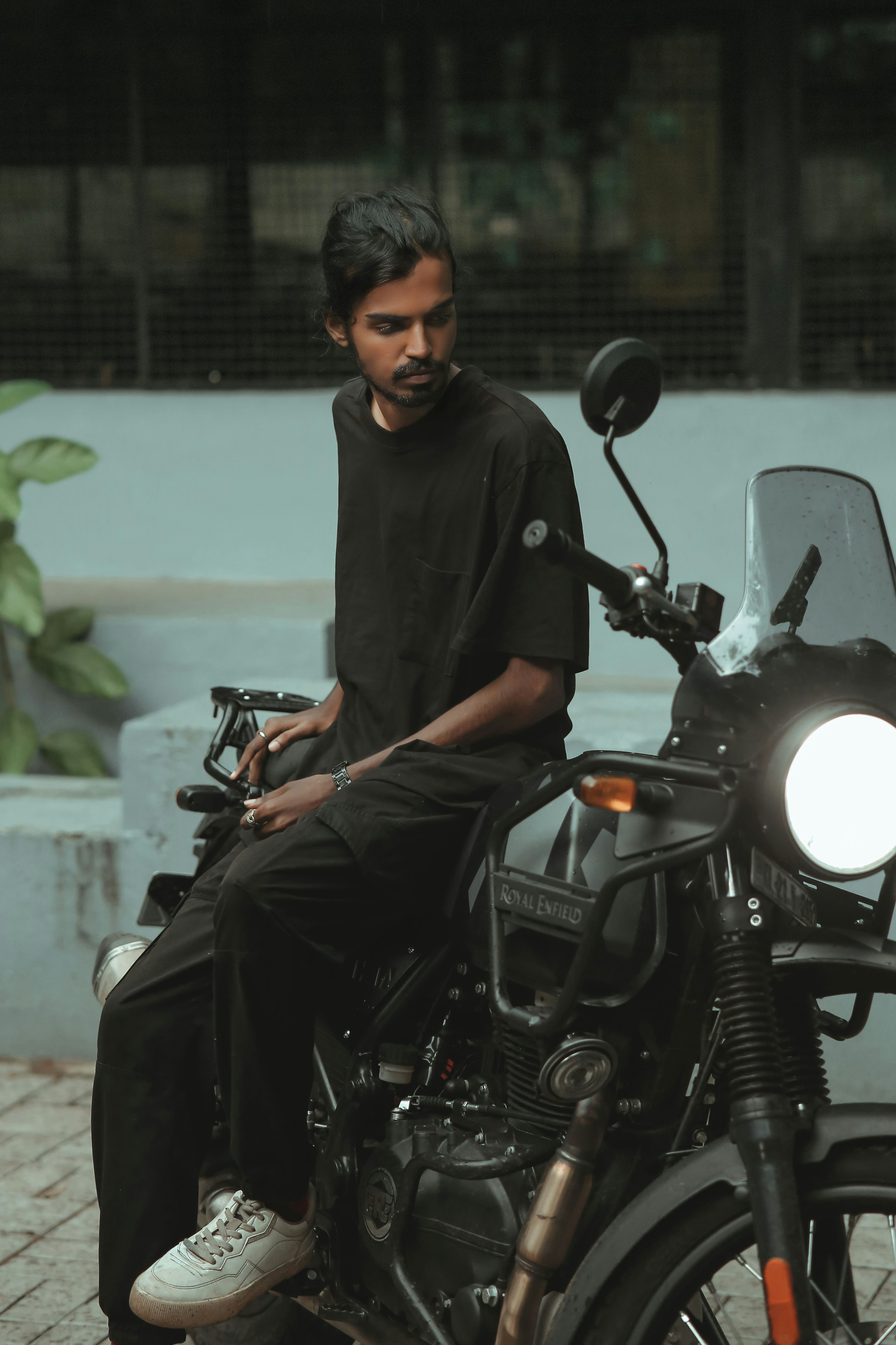 A man sits on a motorcycle.