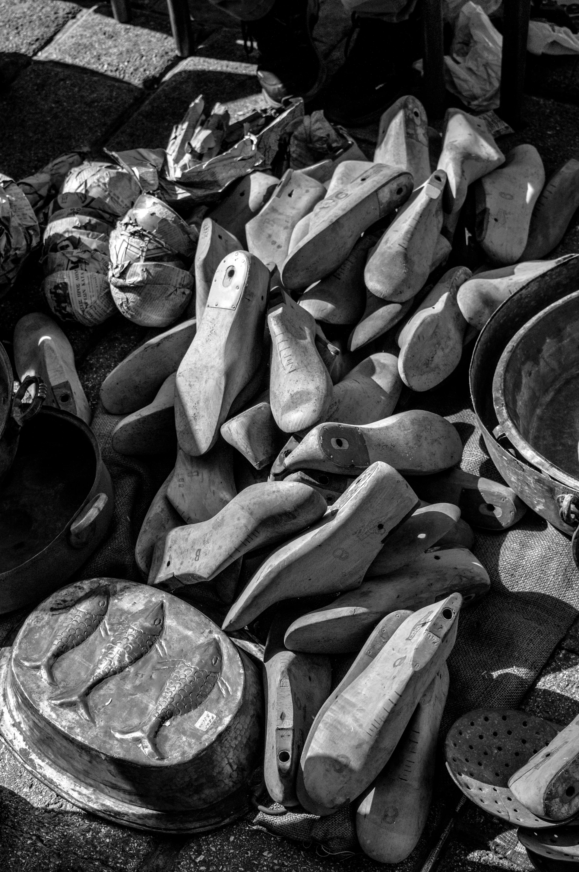 Shoe lasts and other items in a heap.