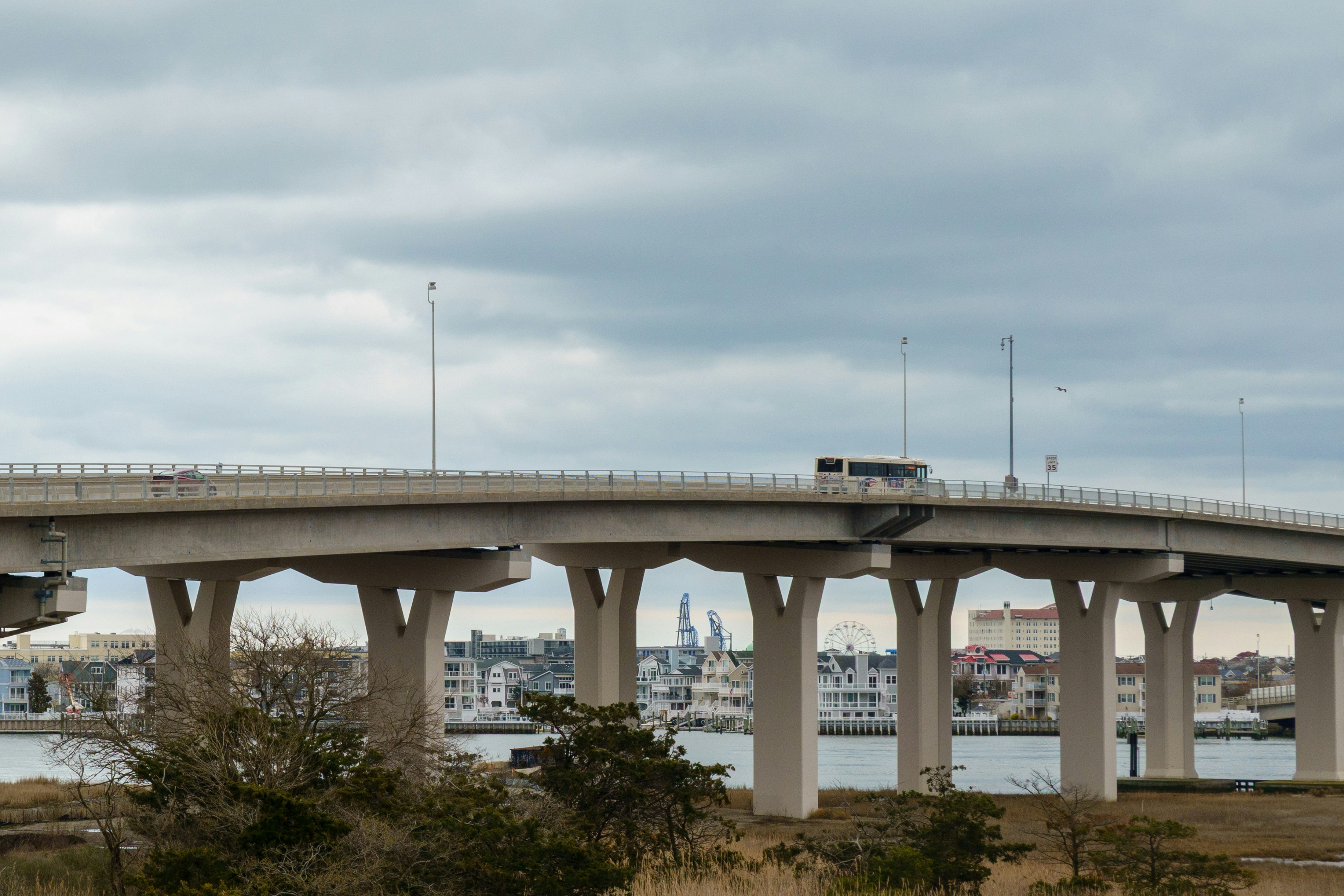 A bridge is seen under a cloudy sky.