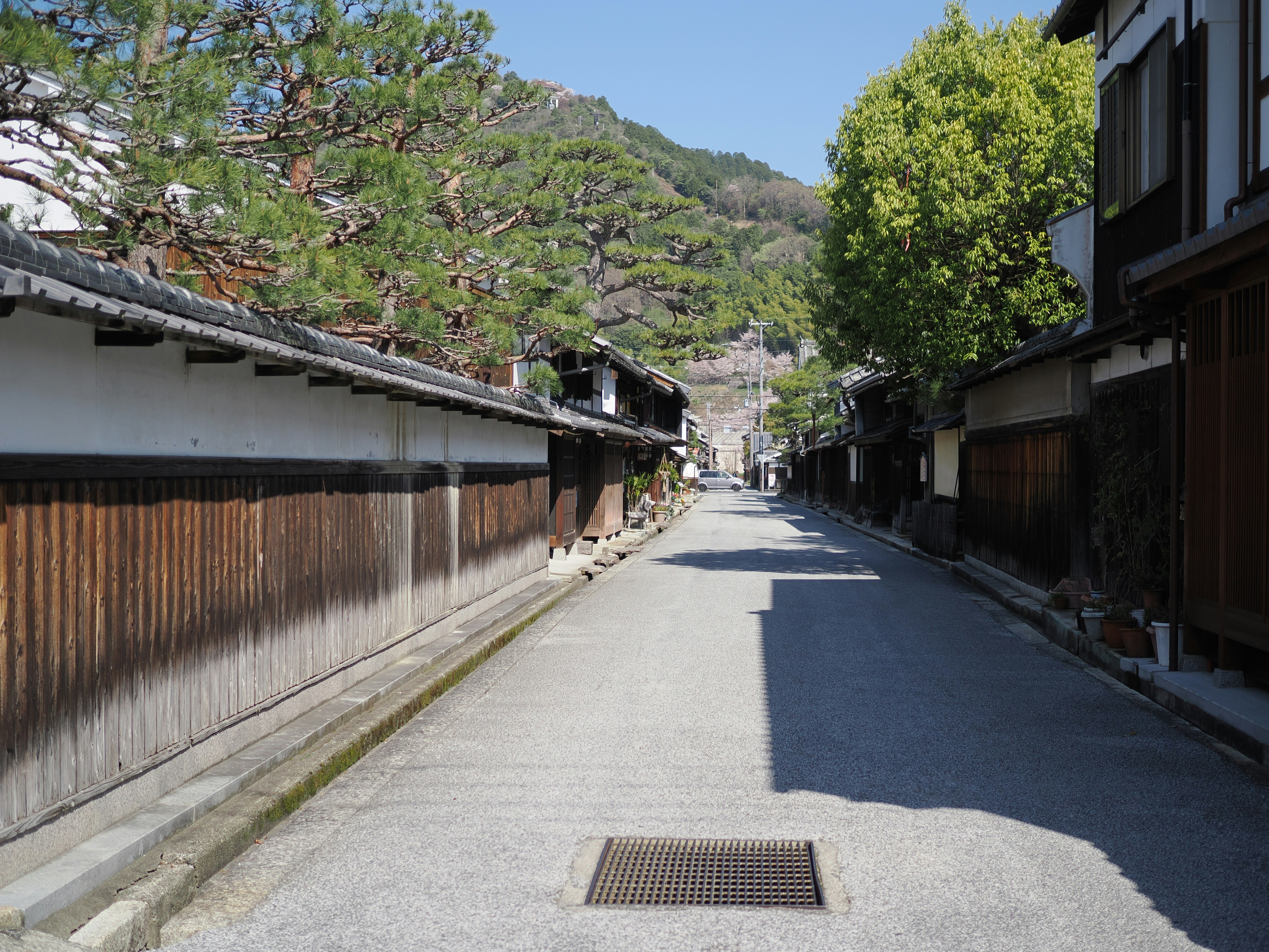 A narrow street lined with traditional japanese buildings.