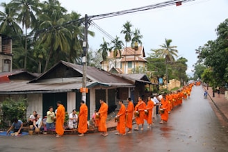 CCI Belgium Laos Buddhist monks receive alms in the early morning.
