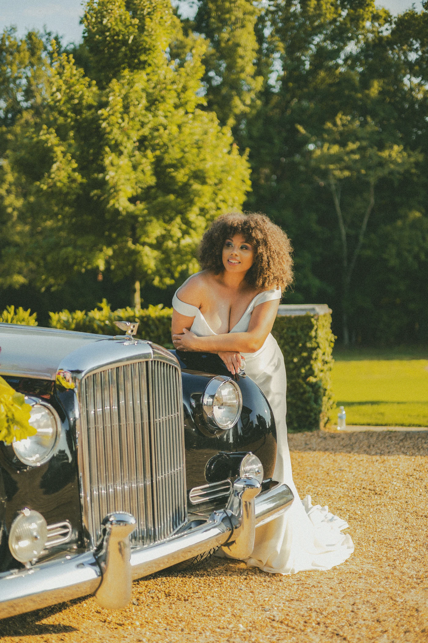 Wedding transportation options for large bridal parties — A sleek wedding shuttle van lined up at a venue for guest transport