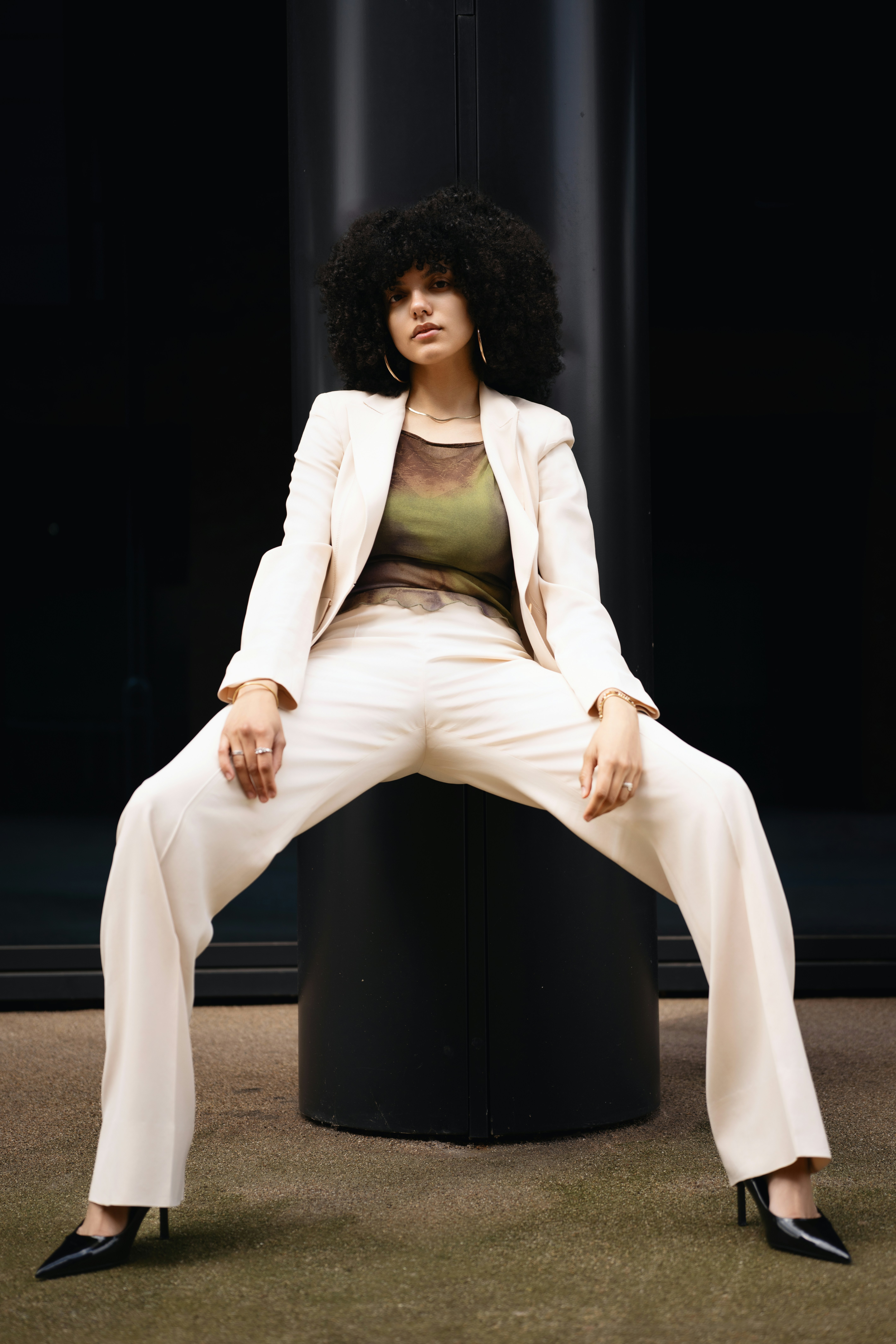 A confident woman poses in a stylish suit.
