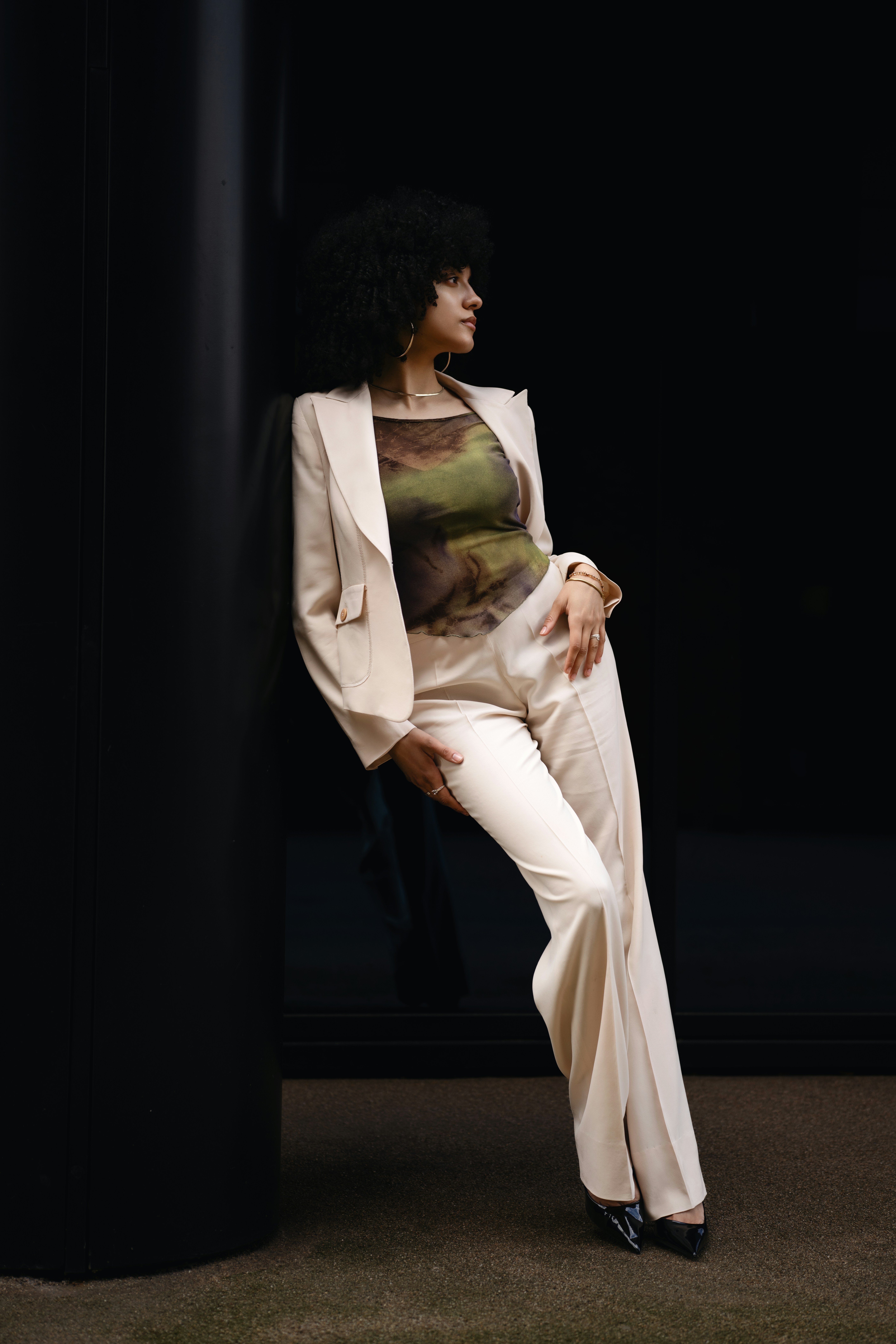 A woman poses in a stylish suit.