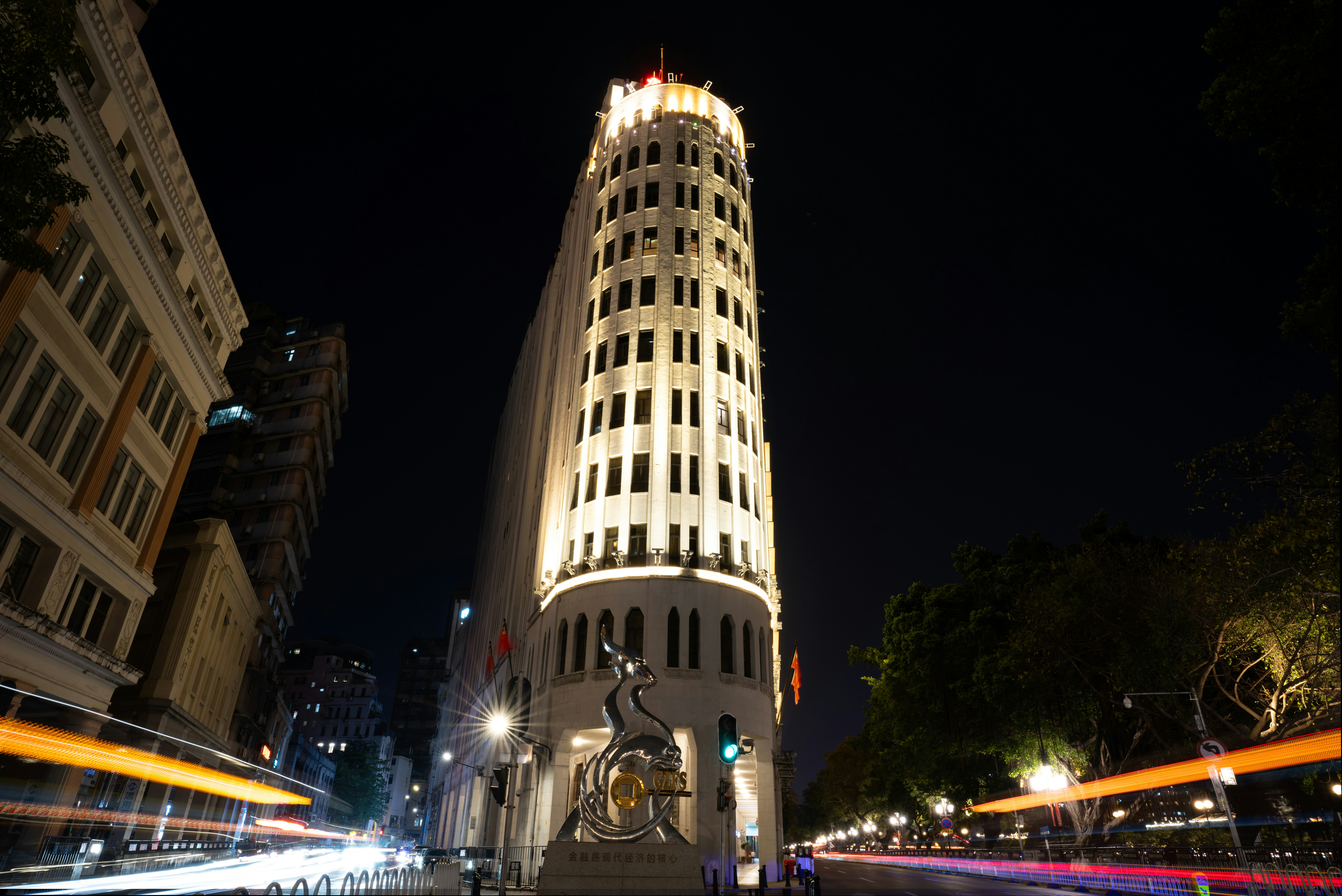 A tall, illuminated building at night.
