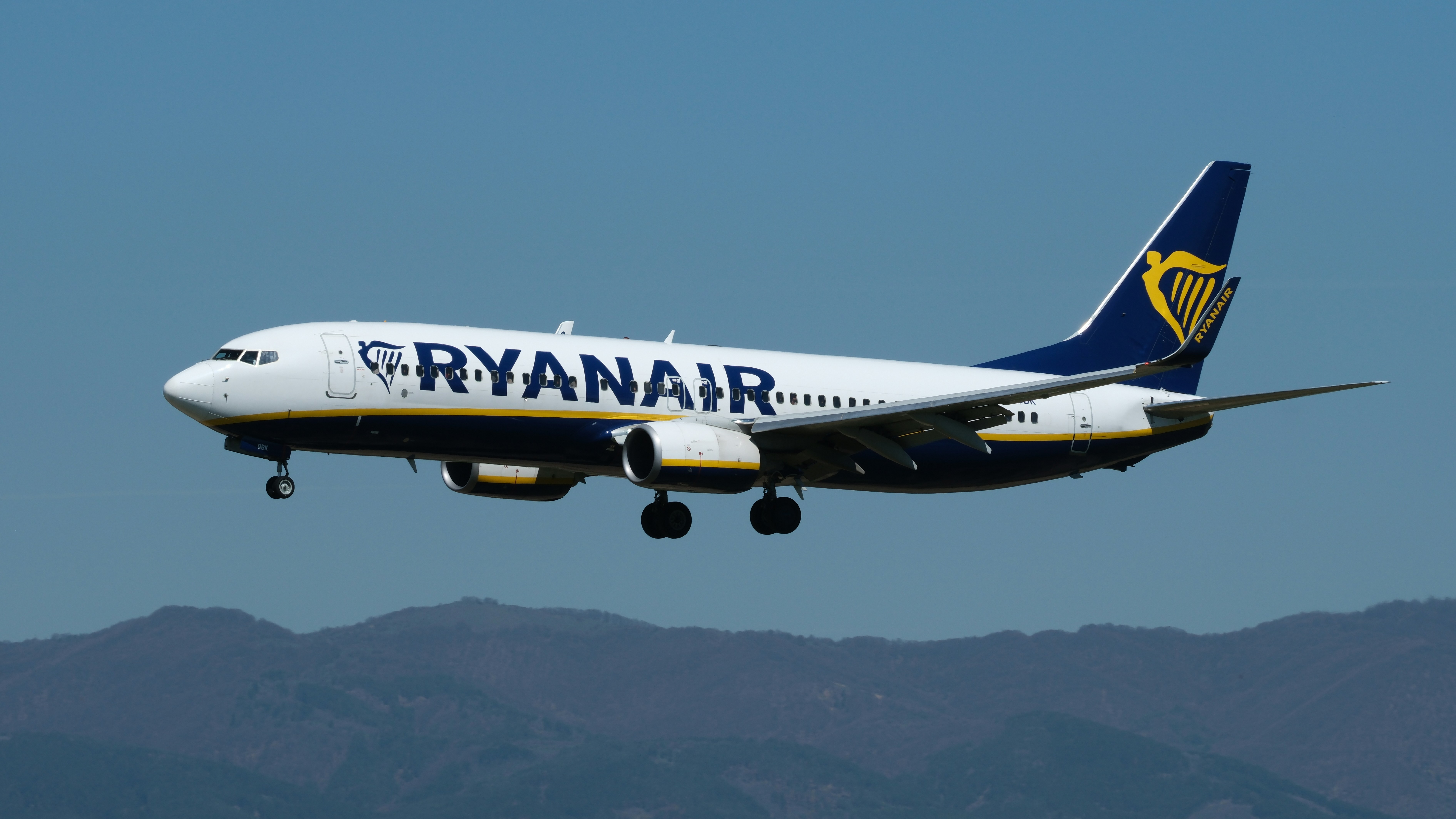 A ryanair airplane is flying through the air.