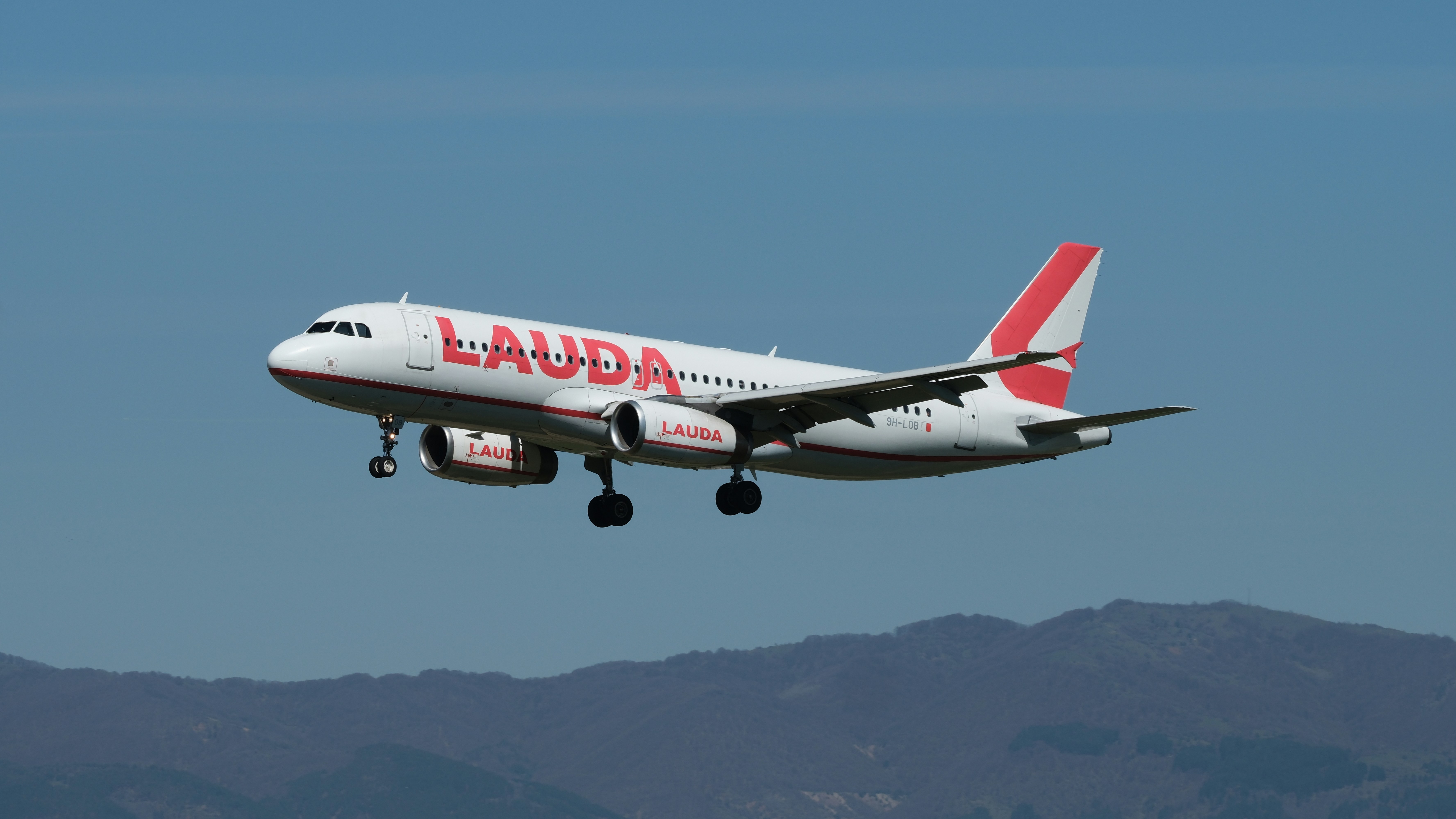 Lauda airplane prepares for landing in the sky.