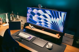 Stylish desk setup with a large monitor and gadgets.