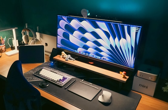 Stylish desk setup with a large monitor and gadgets.