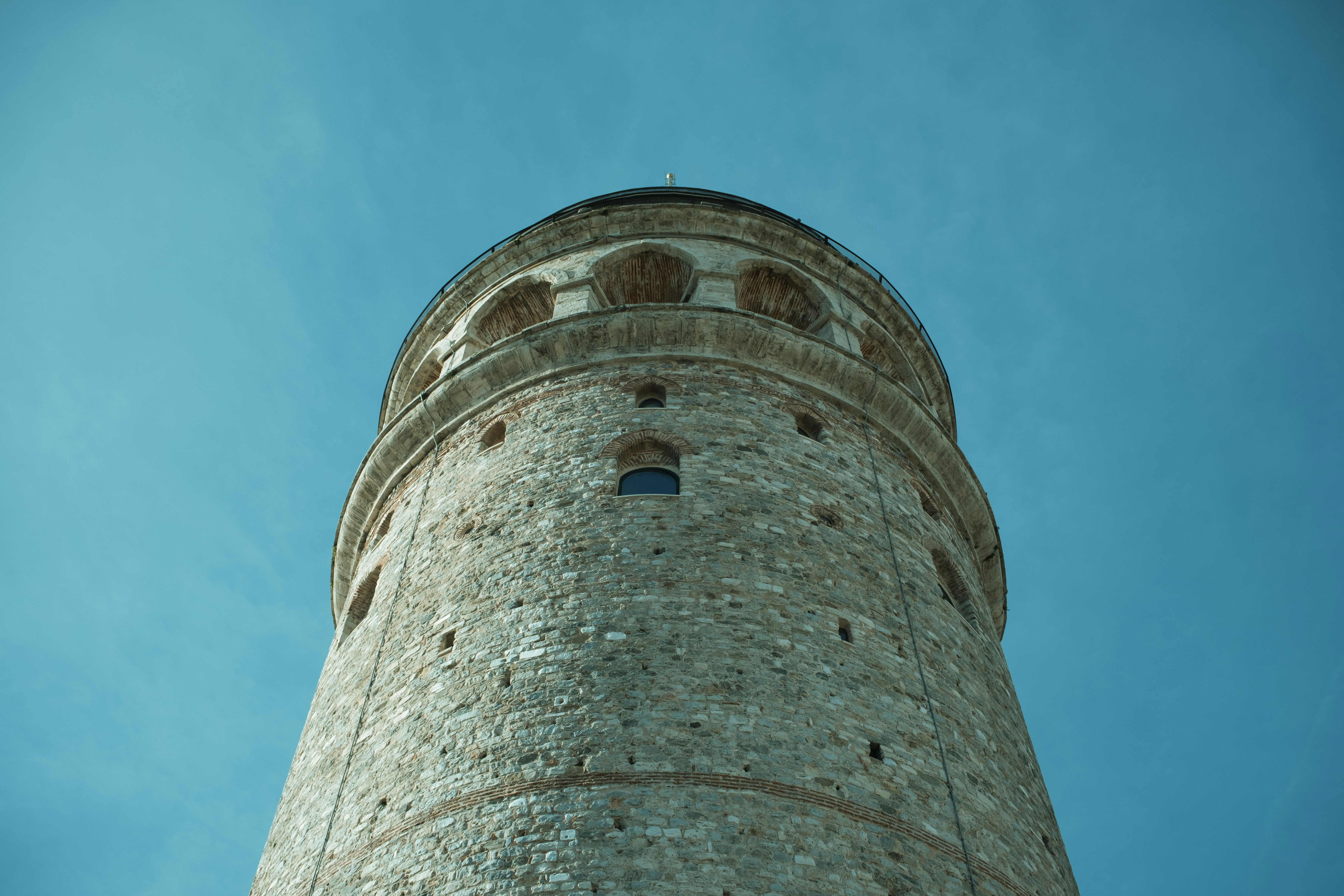 The galata tower rises against a blue sky.