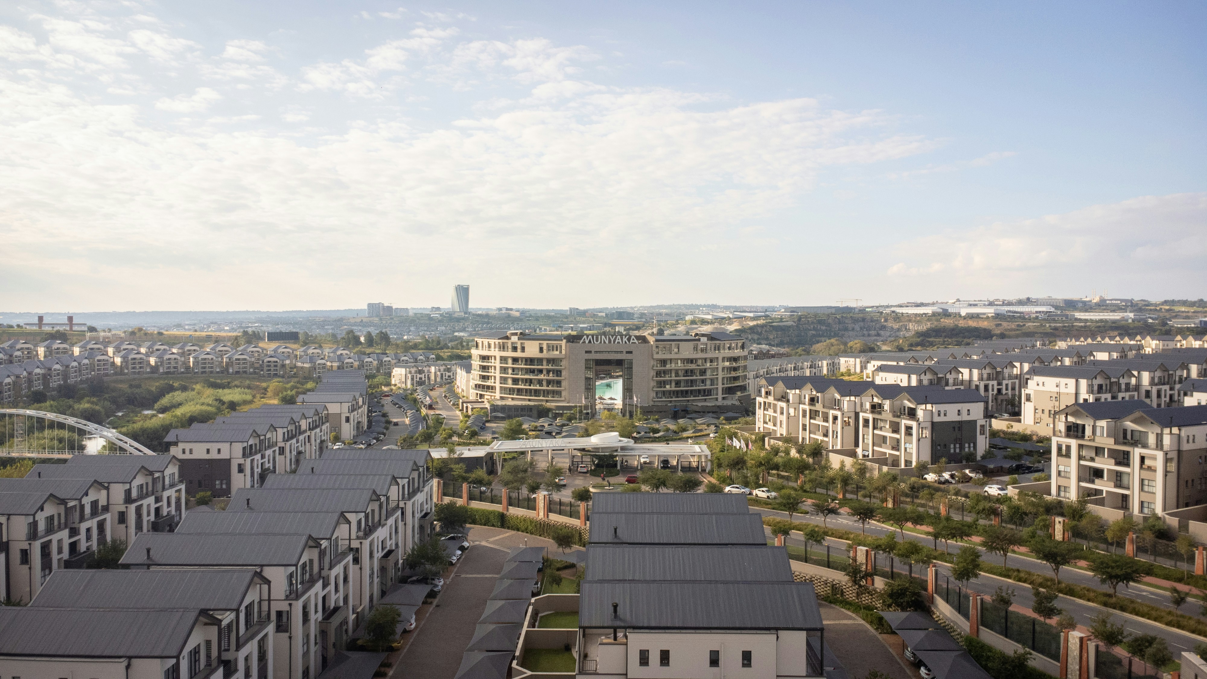 A wide view of a city under a cloudy sky.
