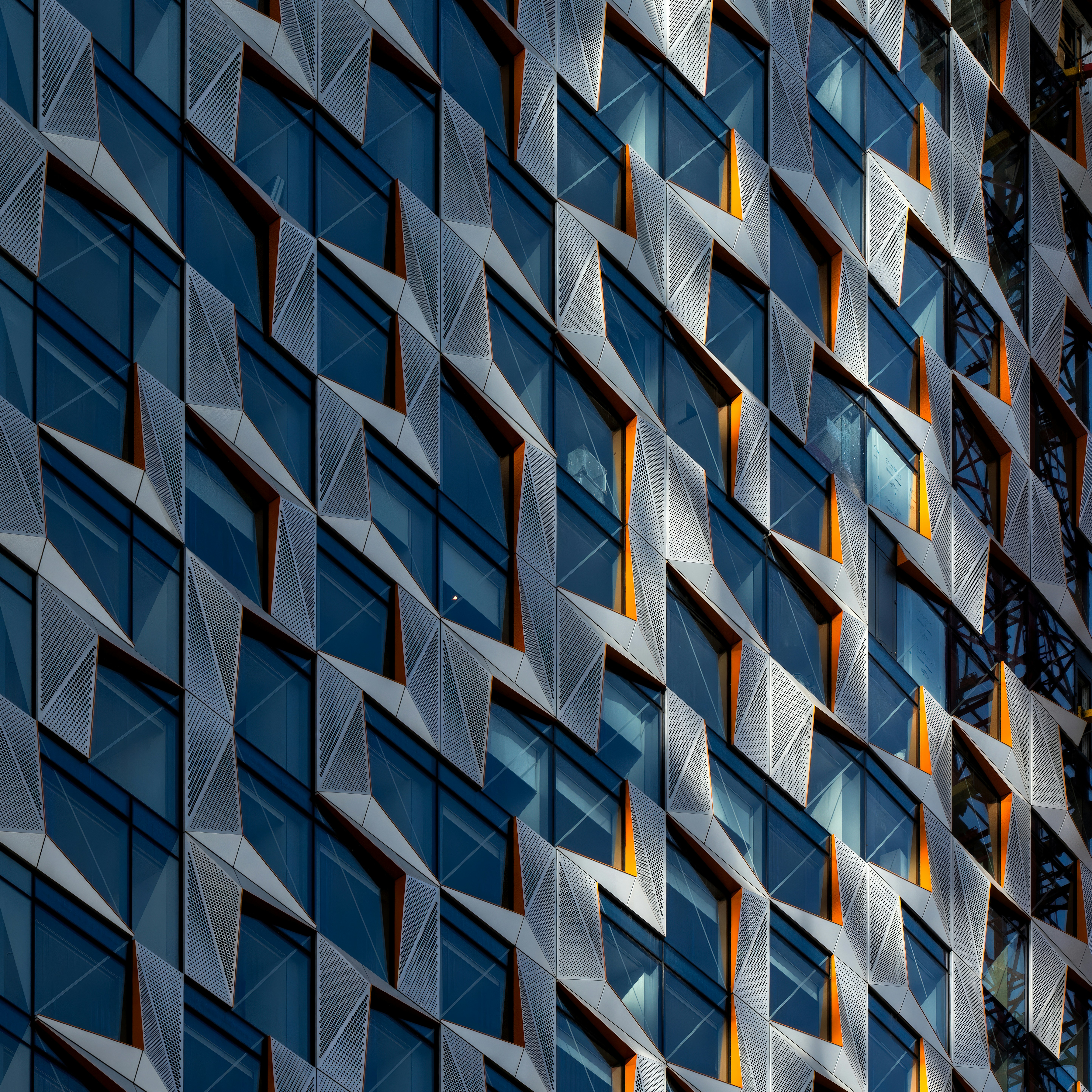 Geometric architecture featuring many windows and sunlight.