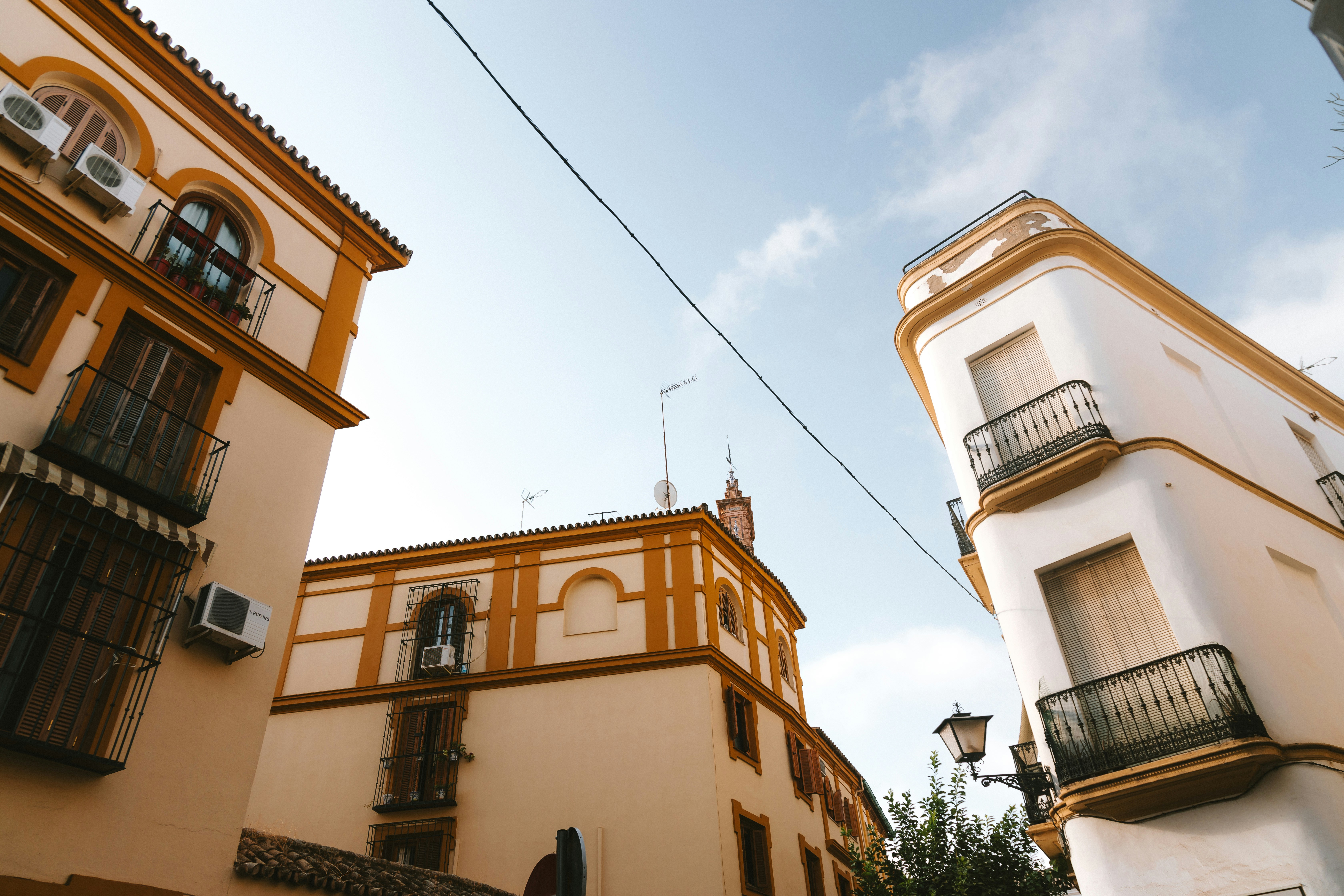 Buildings with architectural details against a blue sky.