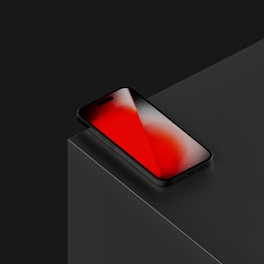 A black phone with a red screen.
