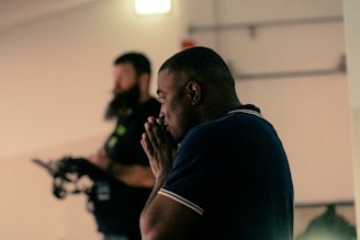 Man is deep in thought with another person behind.