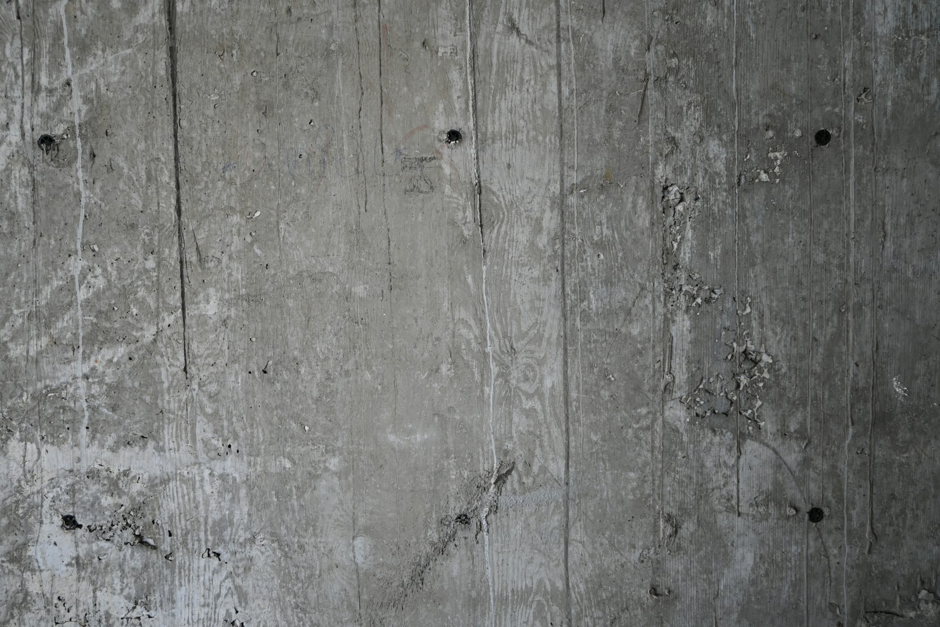Concrete wall with various stains and holes.
