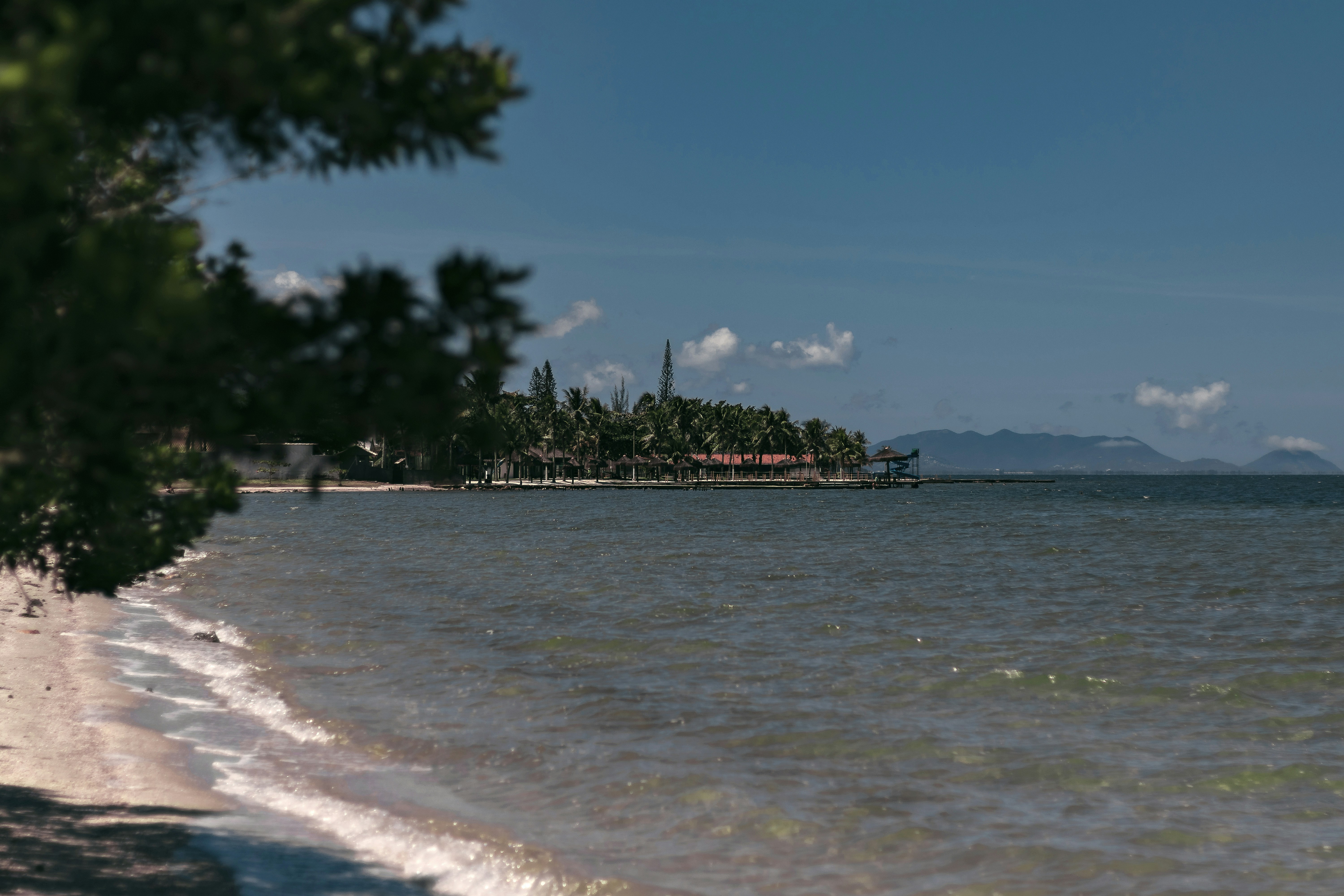 Beach with clear water on a sunny day.