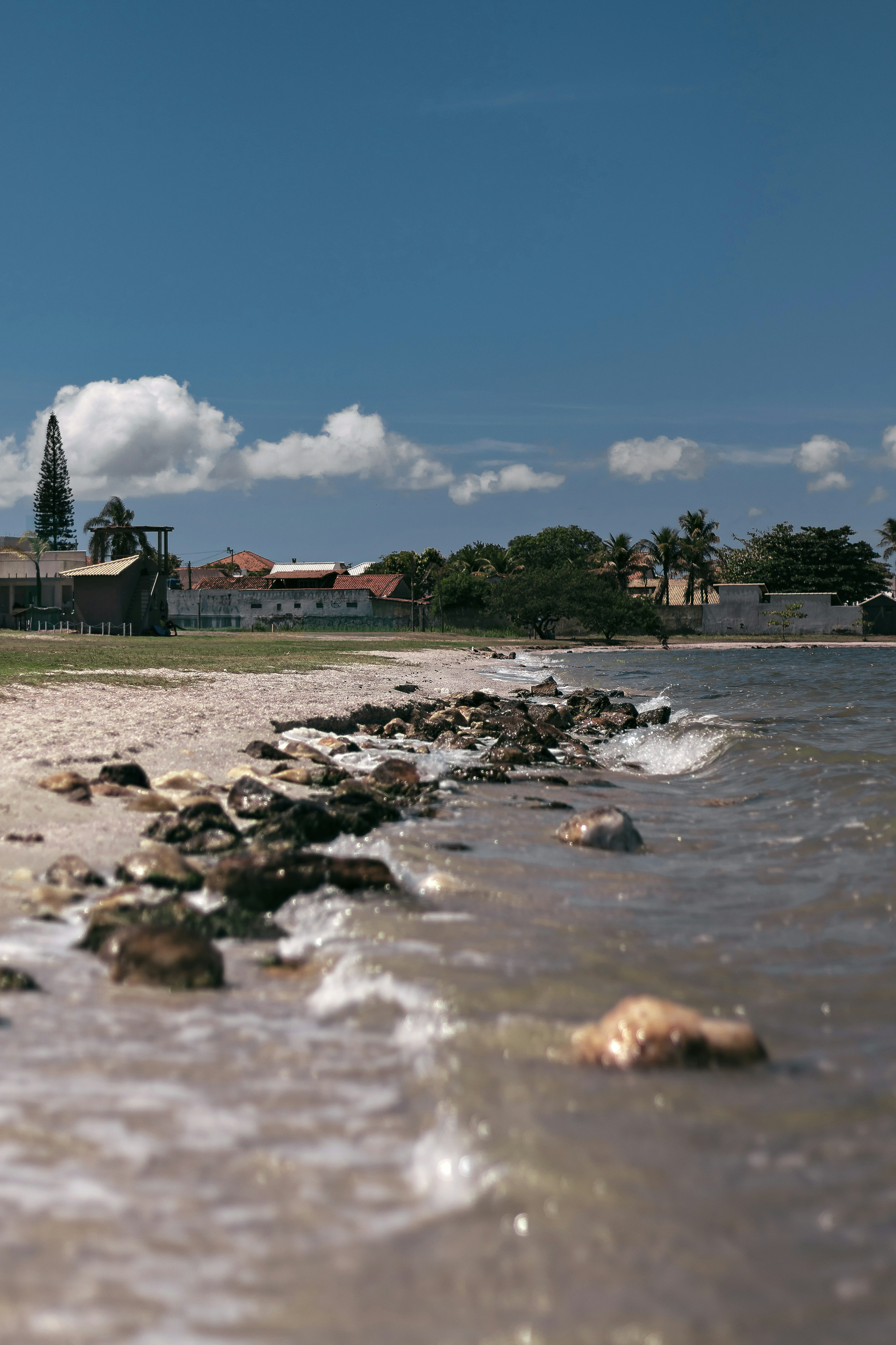 A beach scene with buildings in the distance.