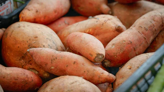 A pile of sweet potatoes in a basket.