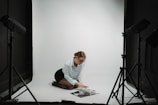 Woman poses in a studio for a photoshoot.