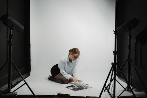 Woman poses in a studio for a photoshoot.
