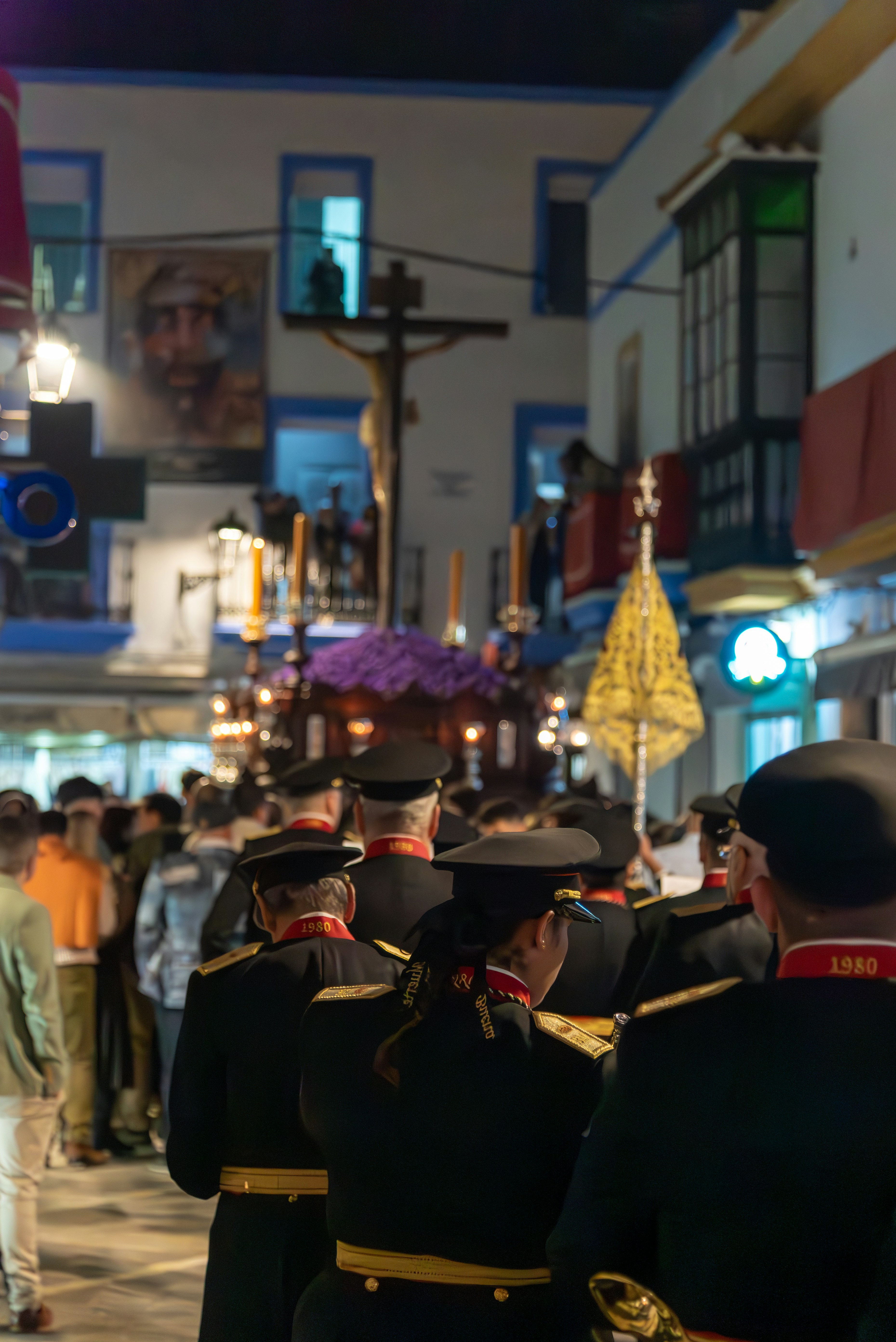 A religious procession is walking down a street.