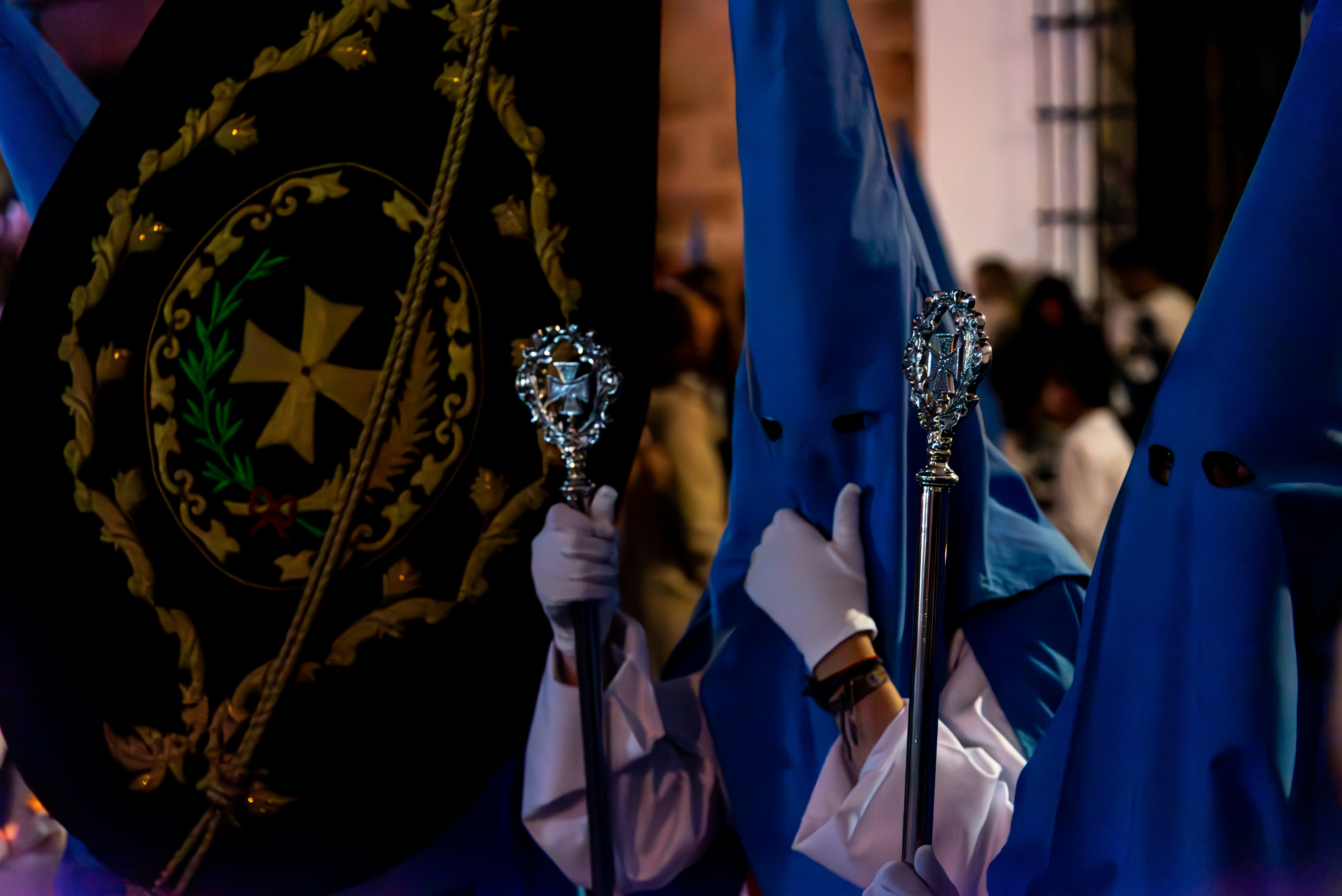 People wearing hooded robes in a religious procession.