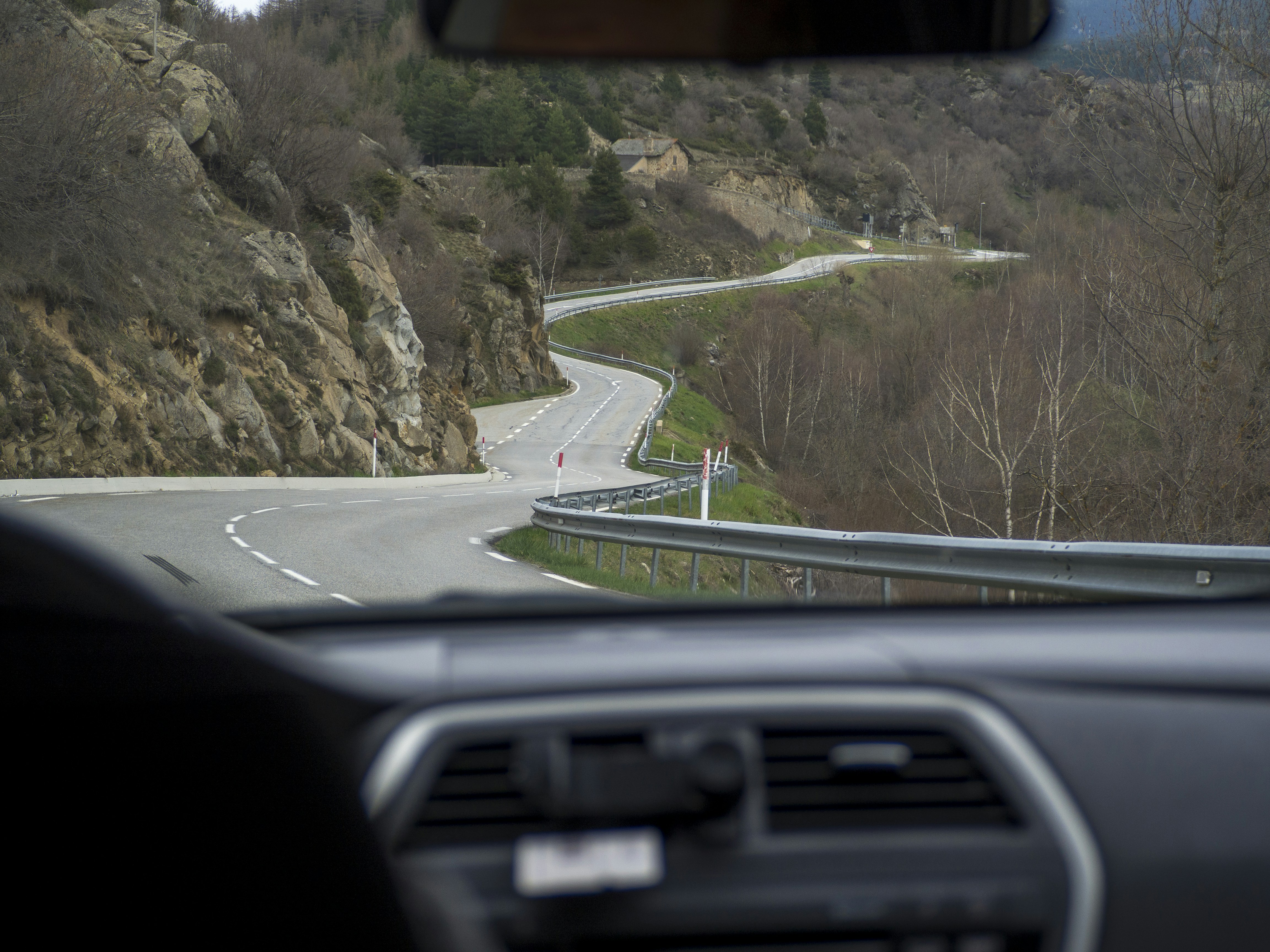 A winding road seen from inside a car.
