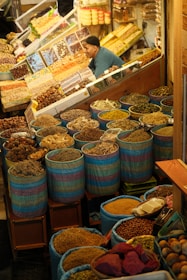 A vibrant spice market stall is full of goods.
